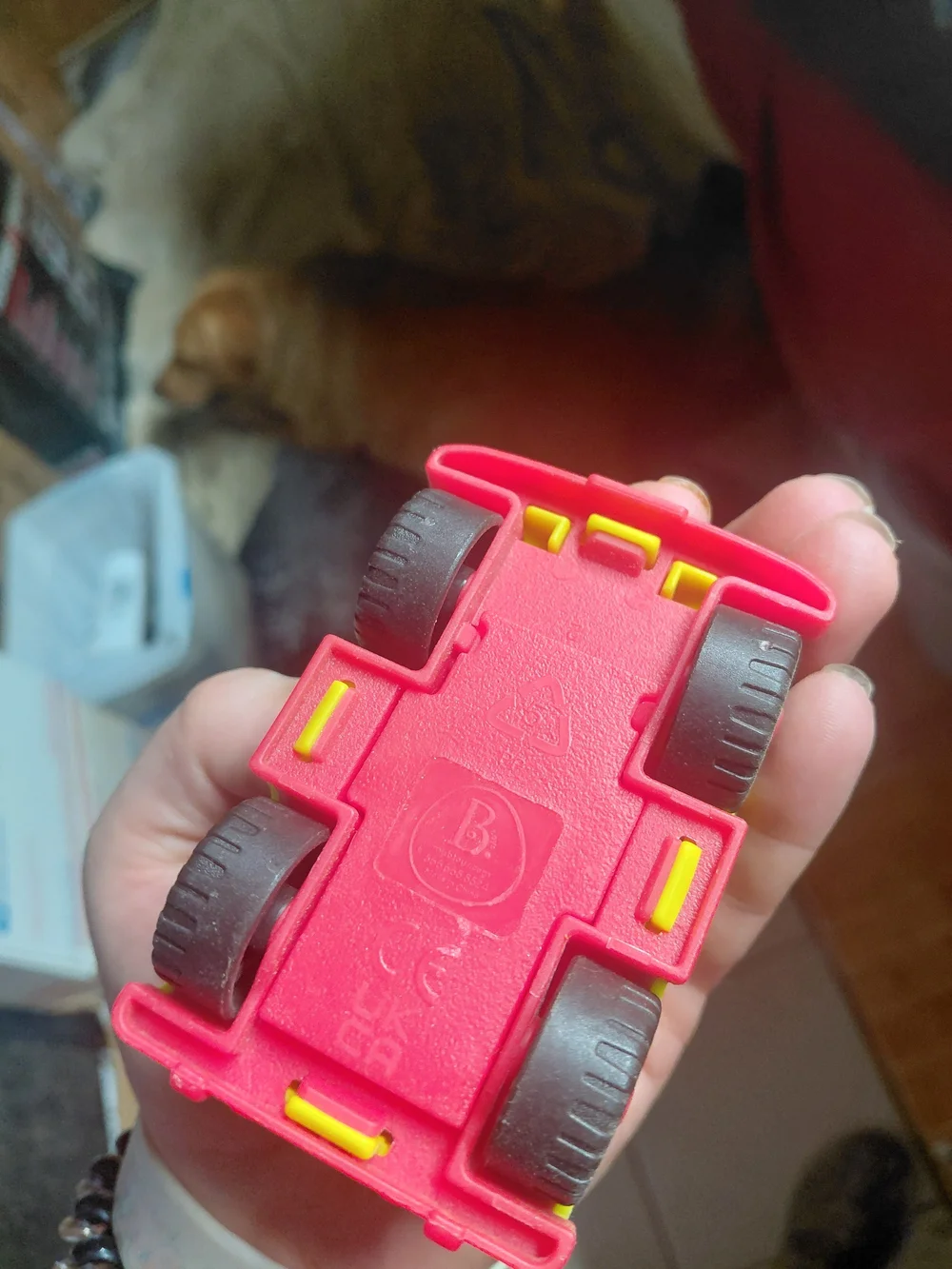 yellow toy vehicle is a B. toys Happy Cruisers Mini 4x4, featuring chunky wheels